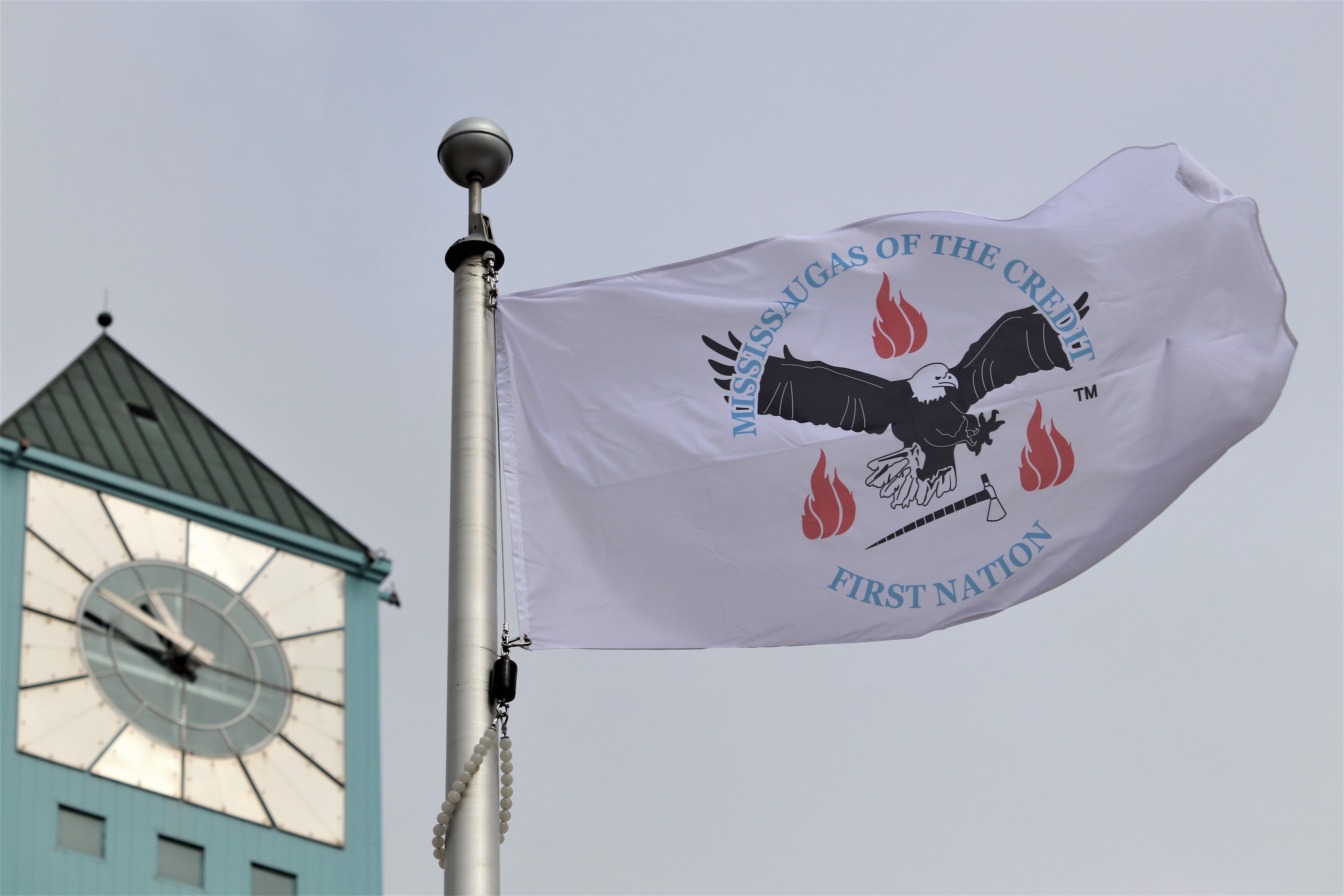 MCFN flag flying in front of clock tower.